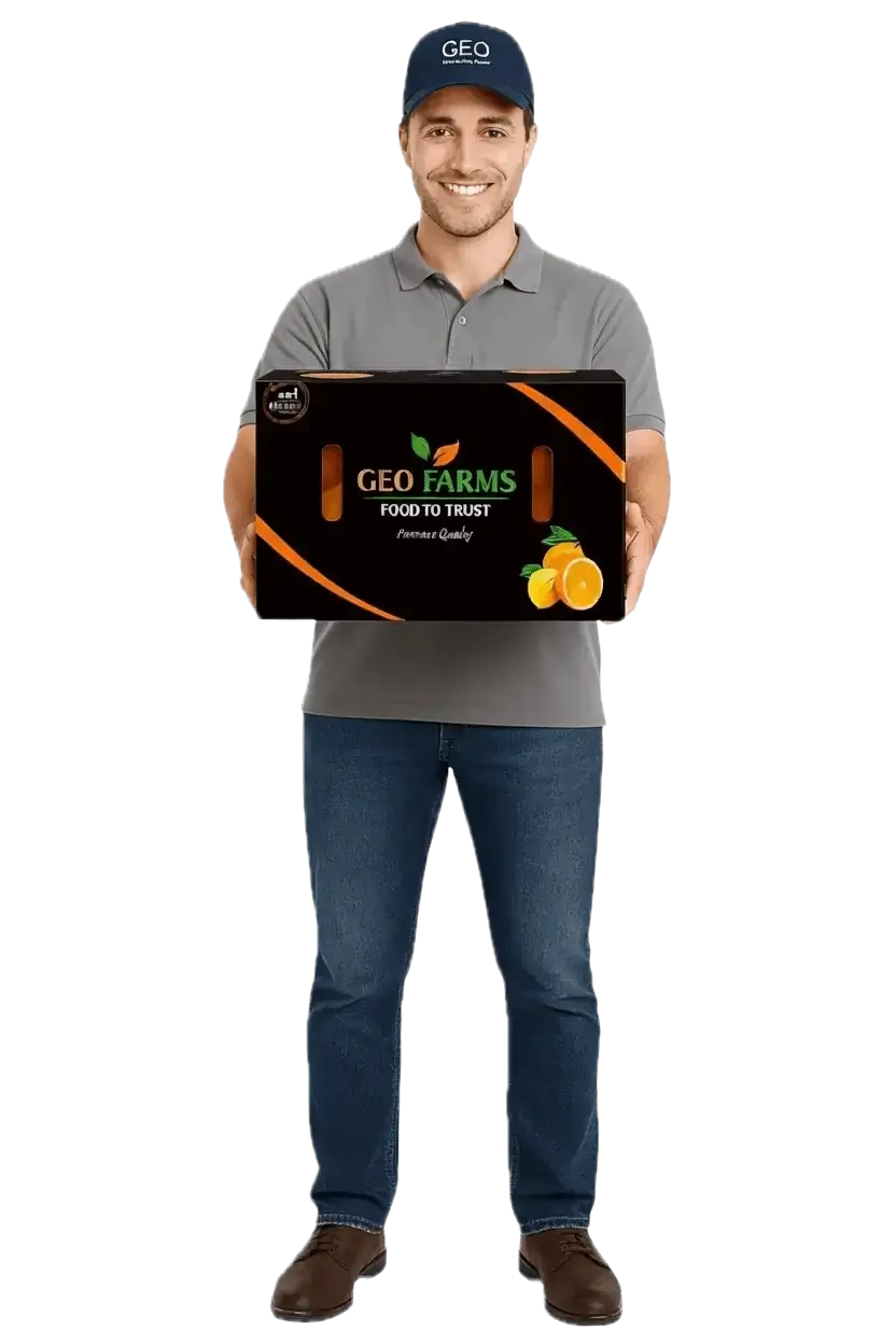 Smiling delivery person in GEO EXPORTING uniform holding a box of fresh Egyptian citrus (oranges and lemons) from GEO FARMS.