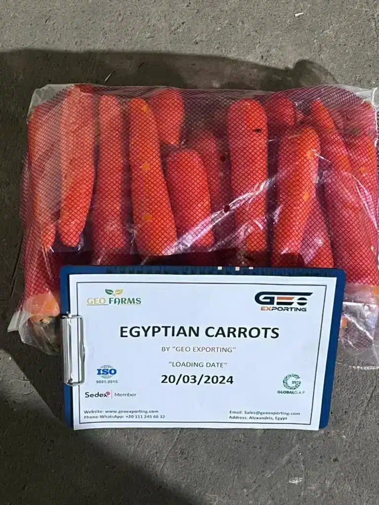 Red mesh bag of Egyptian carrots displayed with a clipboard showing loading date 20/03/2024 and ISO, Sedex, and GlobalGAP certification logos.